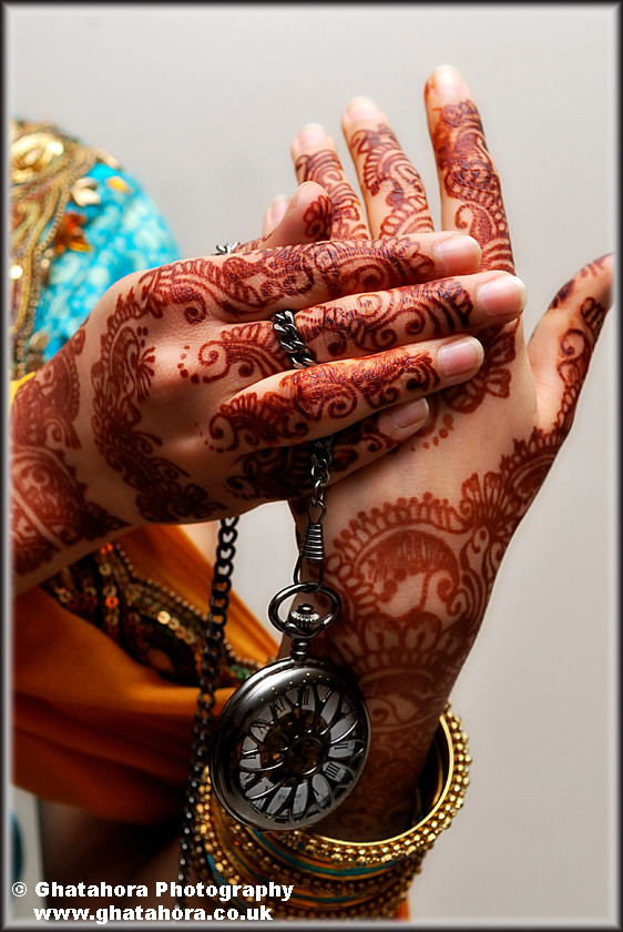 IMG6950 
 Close-up of both hands showing the henna, with the clock locket hanging from the arm. 
 Keywords: Close-up of both hands showing the henna, with the clock locket hanging from the arm. Henna, mendhi, designs, wedding, indian bride, hands, patterns, fashion, body art, tattoo, hands, colour, Bhupinder Ghatahora, Ghatahora Photography